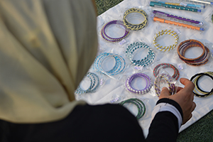 A refugee showing the bangles she made in the safe shelter. Photo: ICMC/ S. Bukhari Refugee showing the bangles she made.