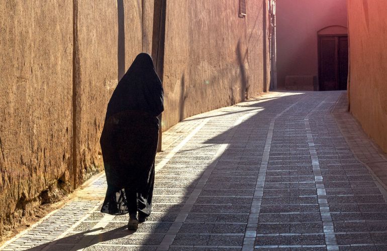 Veiled woman in street