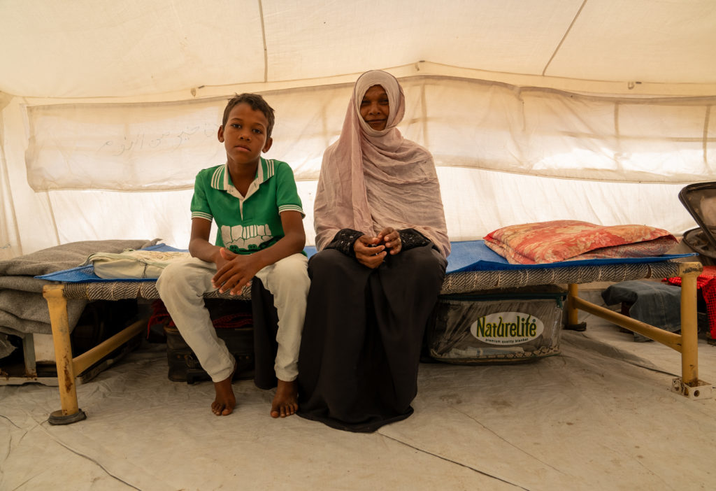 An internally displaced Sudanese mother and her son in their shelter at the Beit Al Shabab settlement in Port Sudan, Sudan.