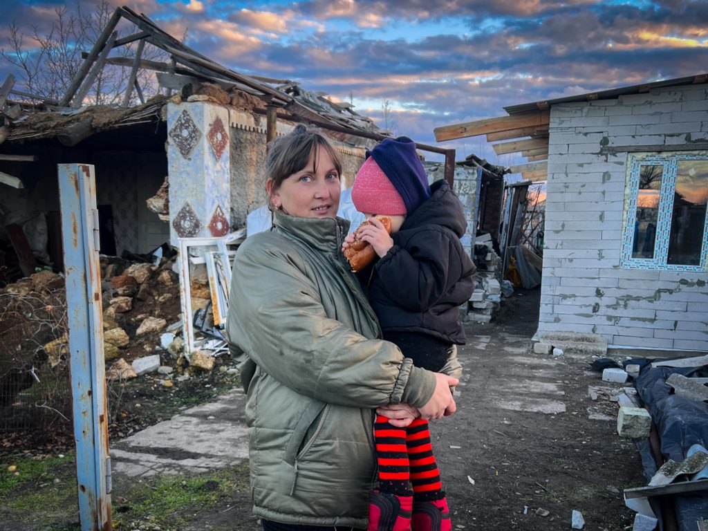 A Ukrainian mother and her child return to rebuild their home in their previously occupied home village