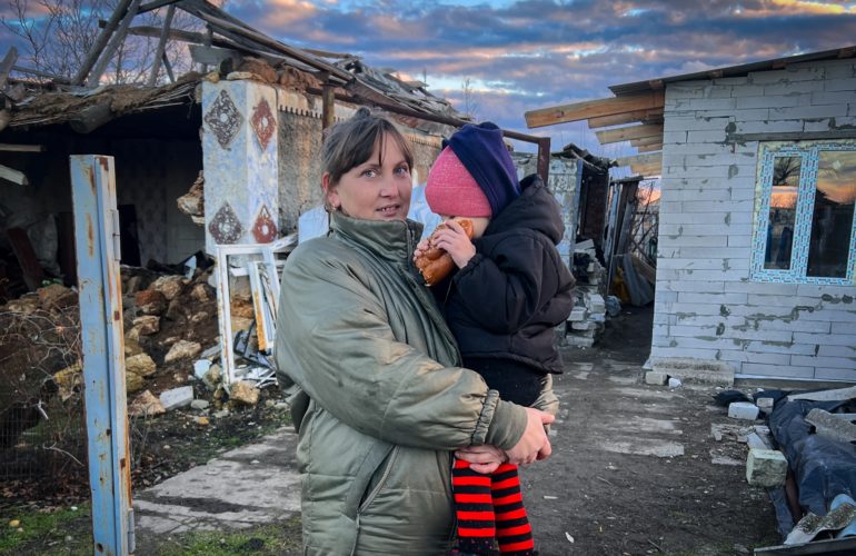 A Ukrainian mother and her child return to rebuild their home in their previously occupied home village